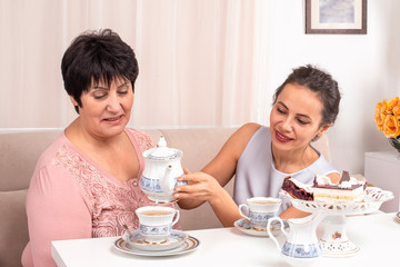 Shot of the mom and adult daughter spending time together at home. © rozaivn58