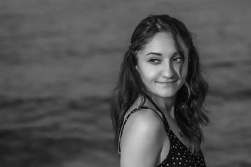 a girl walking at the beach black and white at the beach