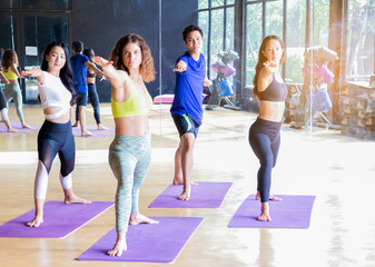 Fototapeta premium group of young women practicing yoga in the gym Concepts of healthy exercise and meditation
