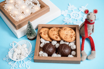 Chocolate marshmallows, white sugar candies and homemade cookies on a shiny background.Birthday present, valentine's day or christmas