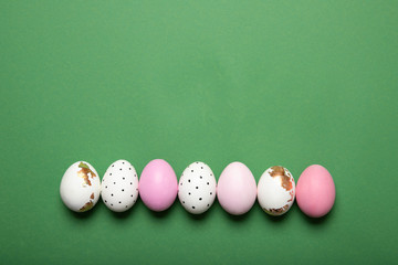 easter eggs on green background, place for text, top view, isolation