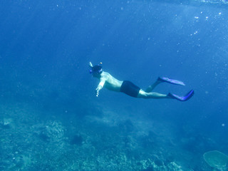 Fototapeta na wymiar Underwater shoot in a sea and snorkeler on a surface 
