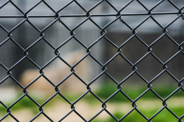 Wire metal fence close up with a blurry background
