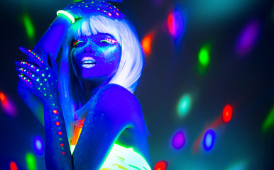 Fashion model woman dancing in neon light, disco night club. Beautiful dancer model girl colorful...