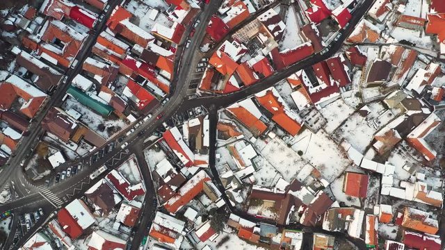 Aerial 4K clip of Brasov old town, bird's eye perspective, at sunrise on a beautiful winter morning