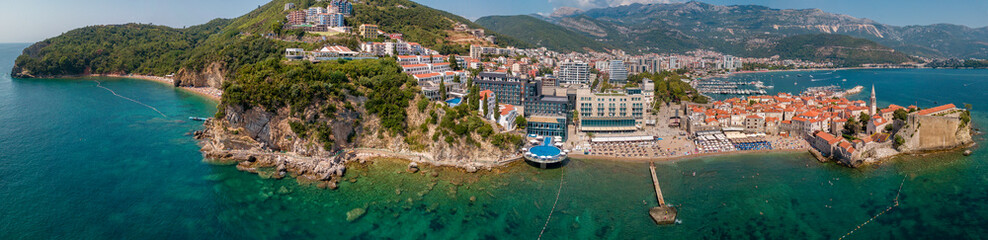 Aerial view of Mogren beach (two sandy beaches) and the old city (stari grad) of Budva. Montenegro....
