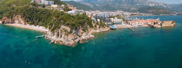 Aerial view of Mogren beach (two sandy beaches) and the old city (stari grad) of Budva. Montenegro. Jagged coast on the Adriatic Sea