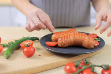 Woman cooking burger for lunch, close-up view
