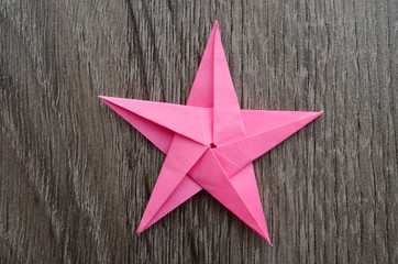 A pink origami paper star