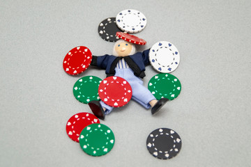 Concept .. Complete loss. A man lies under poker chips. Psychological training