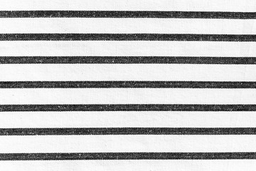 White rough fabric texture background with horizontal black lines striped pattern.