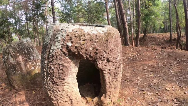 Ancient burial site and bomb crater at Plain of Jars, Laos