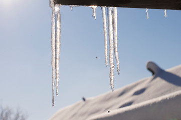 melting icicles against the sky