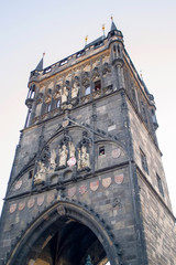 Landmark of the Old Prague - Old Town Bridge Tower next to Charles brige. Majestic bottom-up view.