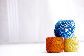 colored wool threads on a white background