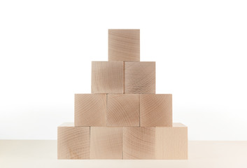 close-up of pyramid of wooden toy blocks against white background template