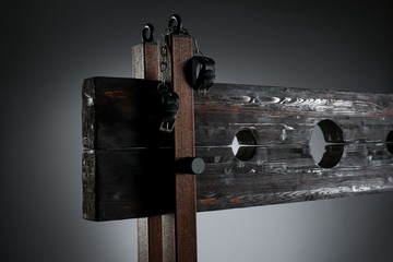 Handcuffs hanging on pillory for BDSM session - obrazy, fototapety, plakaty