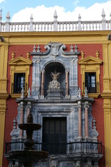 View on the front facade of the colorful Palacio Episcopal / the Bishops Palace in Malaga, Spain, Europe