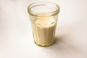Glass of milk or cream diary drink. Cow, soy, oat, coconut or almond beverage on white background