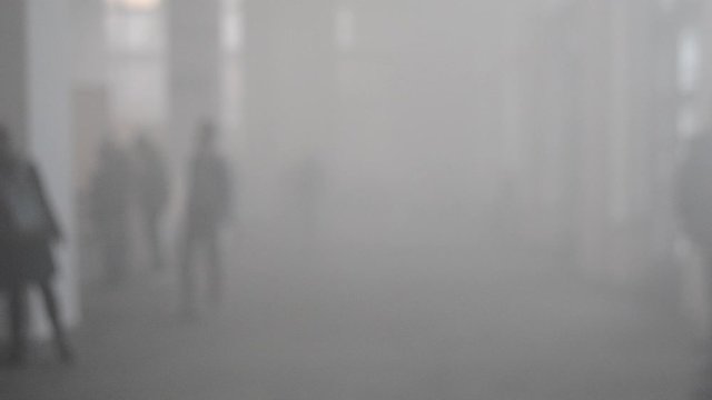 Many People Walk In A Smoke Filled Room