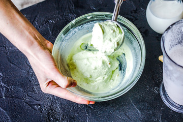 organic ice cream homemade process on dark background with hands