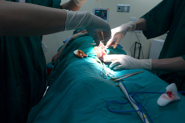 Midsection of surgery team operating Medical Team Performing Surgical Operation in Modern Operating Room or Group of surgeons in operating room with surgery equipment.