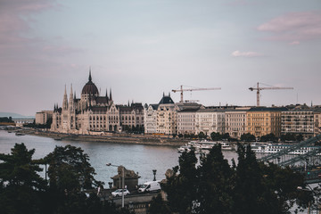 Budapest Parliament House during sunset with river passing through 