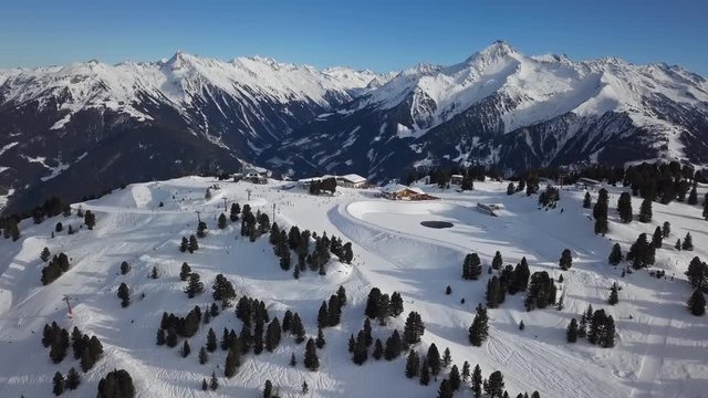 Aerial view of skiers on ski slopes in Penken area, Mayrhofen ski resort, Tyrol, Austria.