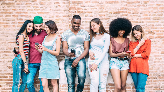 Happy multiethnic friends using smartphone at university college backyard - Young people on addict mood with mobile smart phone - Technology concept with always connected millennials - Filter image