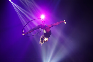 Flexible young woman make performance on aerial hoop, flexiable split on aerial hoop, aerial circus show