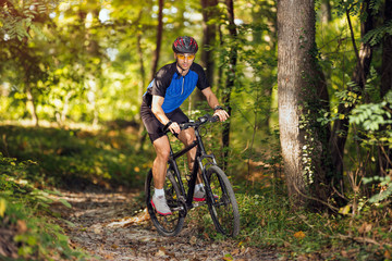 Fototapeta na wymiar sporty man practicing mountain biking.Spring, nature ,sport concept
