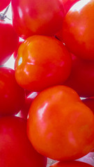 The picture of many tomatoes that are overlapping.