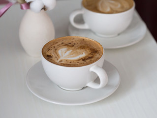 Food. Cup cappuccino coffee, wooden table