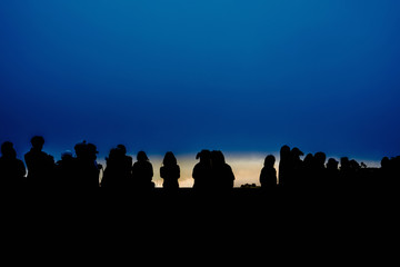 silhouette group of traveler are waiting see sunrise from top of mountain on new year 2020