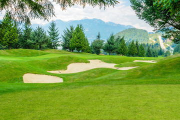Golf course with gorgeous green and sand bunker