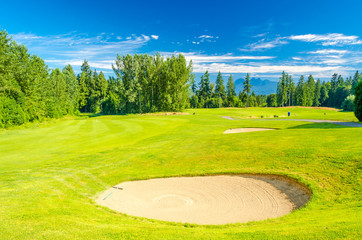 Golf course with gorgeous green and sand bunker