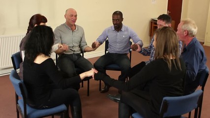 Holding hands in Support group people sat in circle for therapy Counselling session -  Mental Heath, Alcoholic - Stock Video Clip Footage. 