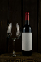 wine bottle and glass on wooden background