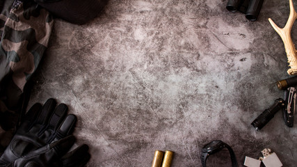 Hunting accessories on a dark background, tactical equipment. Hunting tactical background. The...