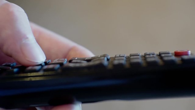 modern technologies.male hand holds a TV remote control.close-up.shallow depth of field