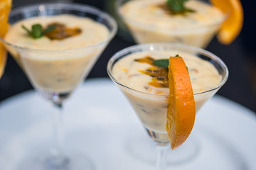 Bright passion fruit mousse decorated with orange slice