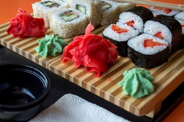 A set of different sushi on a tray in perspective