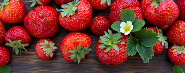 Macro shot on strawberries over wooden background.
