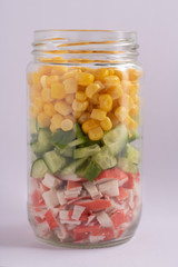 Bright rainbow salad of corn, cucumber and crab sticks . Trends in healthy eating. Selective focus.