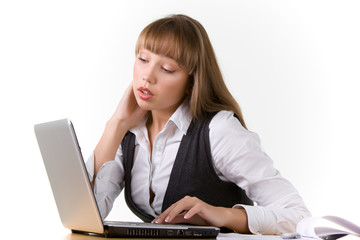 Shocked young girl is looking at a laptop reading messages in social networks. The concept of discounts in online stores. Online shopping concept. Copyspace