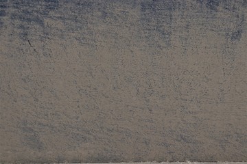 Rough, dirty, brown, dull surface.