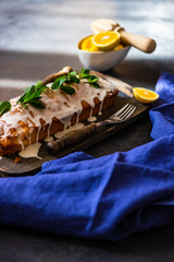 Tasty lemon cake with ingredients on stone background