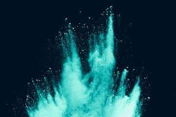 Blue sky color powder explosion on black background.