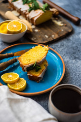 Tasty lemon cake with ingredients on stone background