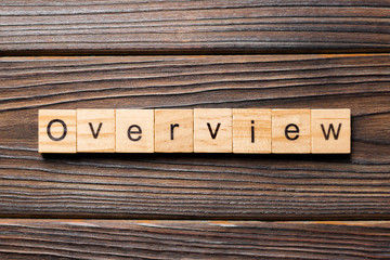 OVERVIEW word written on wood block. OVERVIEW text on wooden table for your desing, concept